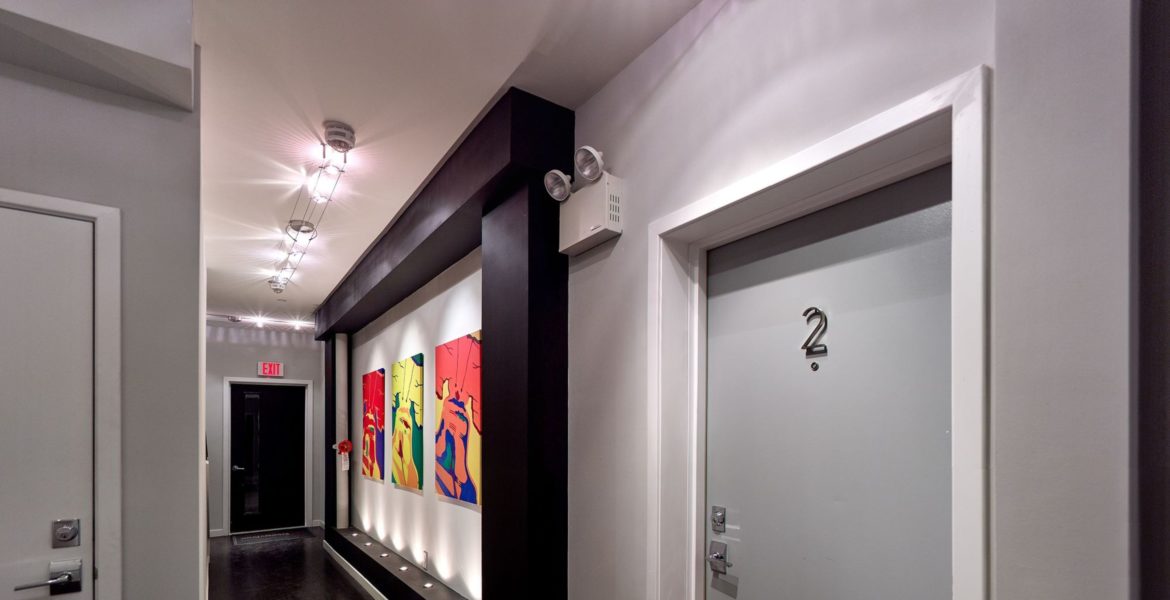 Hallway with art on the walls at The Flats at 31 Brewerytown