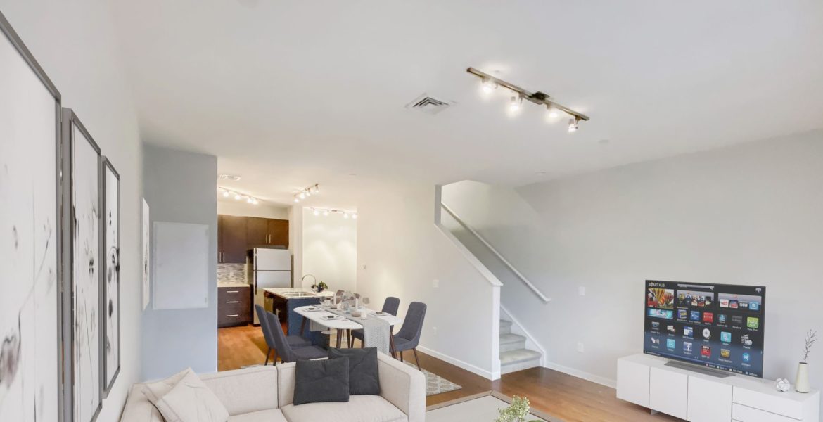 Spacious living room with sectional sofa at The Flats at 3 Brewerytown